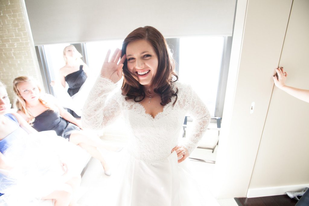 Happy bride in front of a window