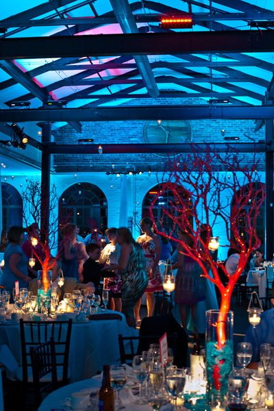 Underwater effect with rich blue lighting and pinspotted red coral branch centerpieces