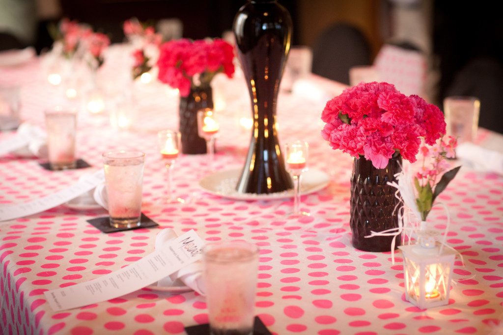 pink polka dot tablecloth linen with black glassware and pink flowers