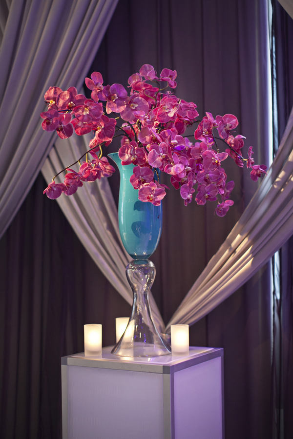 turquoise vase with purple orchids wedding aisle