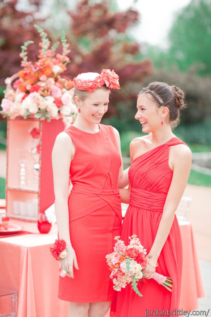 Bridesmaids in red dresses and braided updo and flower hat