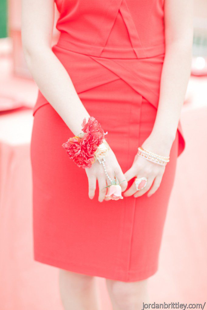 Red dress bridesmaid with flower bracelet and flower ring