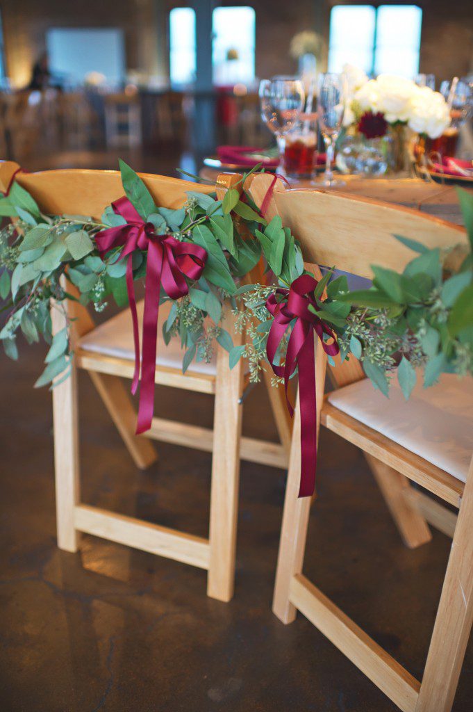Greenery sweetheart table chairs with burgundy ribbons