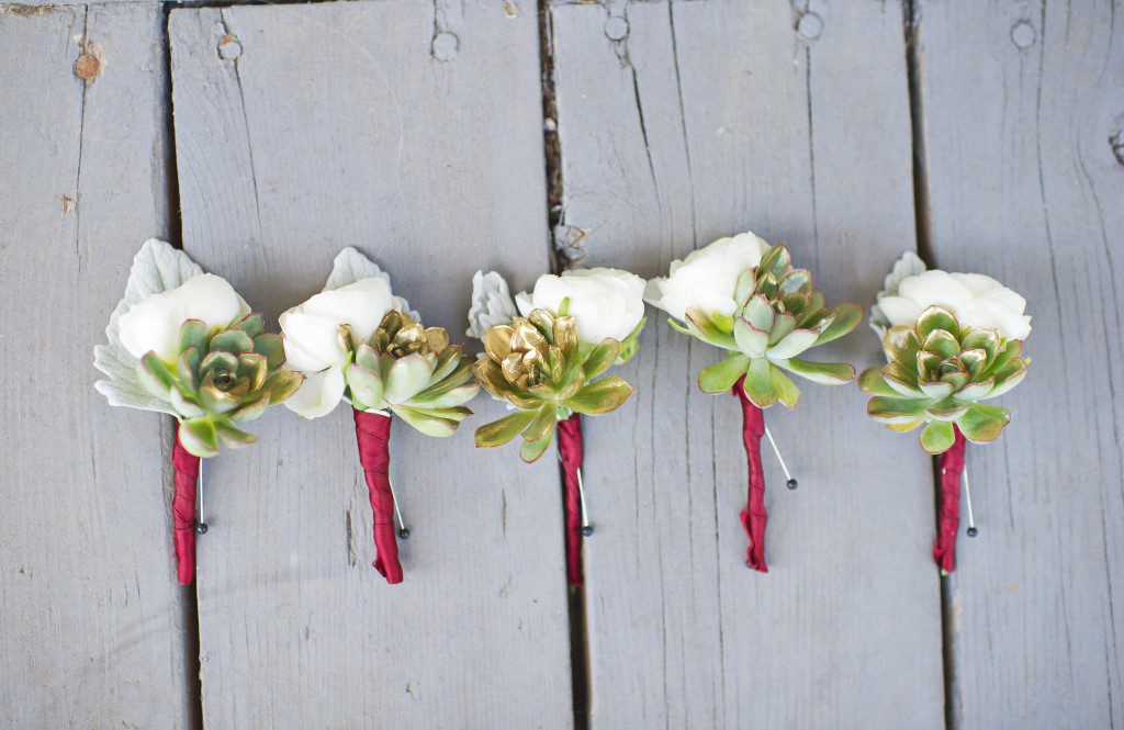 White dusty miller gold succulent and burgundy wrap boutonniere