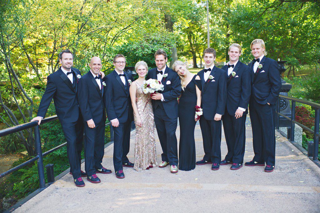 Black and gold wedding party in a park