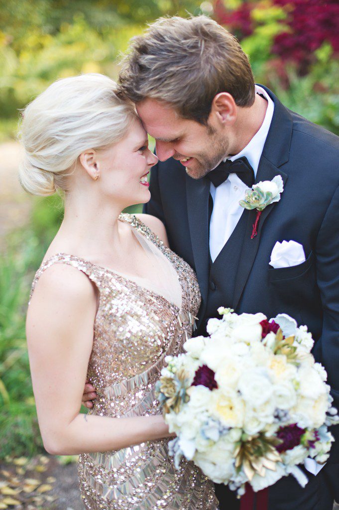 Bride and groom gold sequin dress and burgundy dahlias