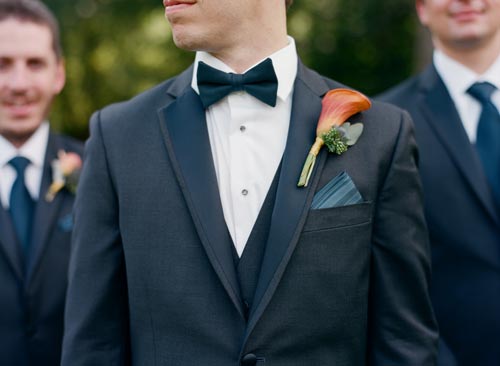 orange and blue calla lilly boutonniere | Events Luxe Weddings